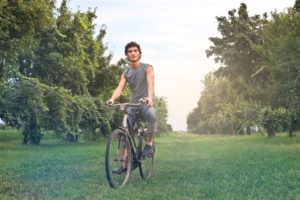 Man on bike in orchard