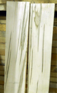 Photo of unfinished boards of maple showing staining from Columbian timber beetle attack.