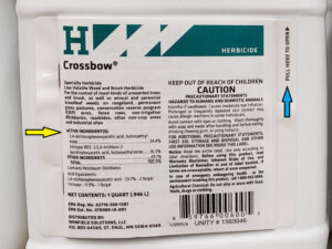 Closeup photo showing active ingredients listed on the front label of pesticide containers. The complete label, including instructions, may be on the front or back of the bottle and will require opening to read.