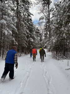 Photo of a snowy trek through the woods at a Vilas County site of a Wisconsin Department of Natural Resources internal audit site.