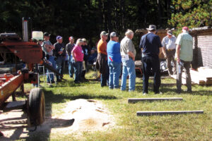 During the 2024 Wisconsin Woodland Owners Association annual meeting near Stevens Point, hosts Jim and Deb Swanson demonstrate their portable sawmill for visitors from the WWOA.
