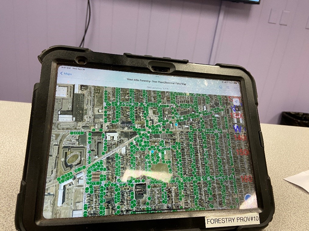 This image shows a tablet that arborists with the City of West Allis take into the field when they conduct tree maintenance. The screen on the tablet shows a map within the Field Maps application.