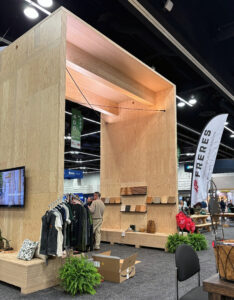A booth made entirely of mass plywood is displayed at an expo.