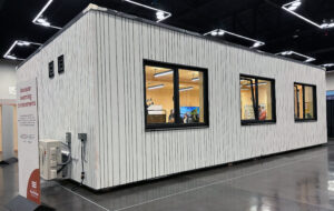 A modular learning environment made of mass timber is displayed at an expo.
