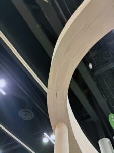 A curving arch made of Canadian mass timber displayed at an expo.