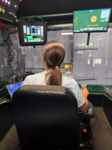 teacher working at a logging equipment simulator